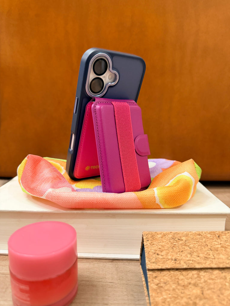 Tech Candy magnetic Back Pocket holds up to 4 cards, is a stand of your phone, and offers a back strap so you can hold your phone with ease. Shown in Dark Plum color.