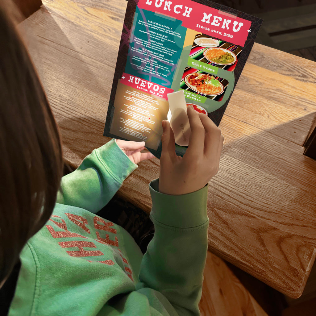 Using a Get Lit light to read a menu in a restaurant