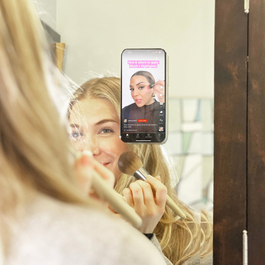 Stick 'Em Up 2-Sided Phone Suction Pad in use on an iPhone in a mirror with a makeup tutorial