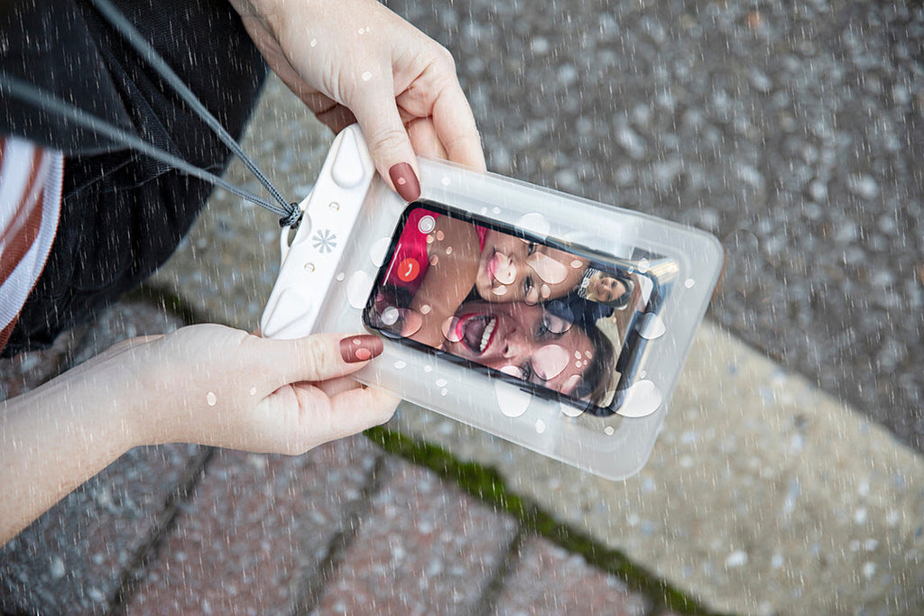 Dry Spell Phone Water Defender Bag in the rain